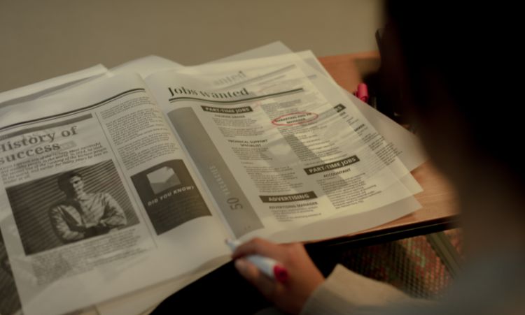 Shows someone looking for a job