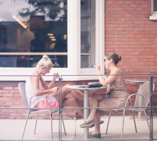 Shows two women gossiping